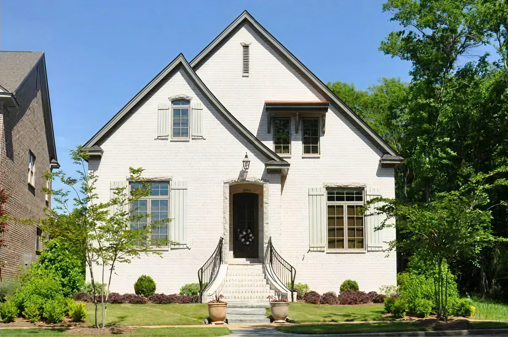 Modern farmhouse custom home with black windows and white brick built by Inspiration Homes near Franklin, TN