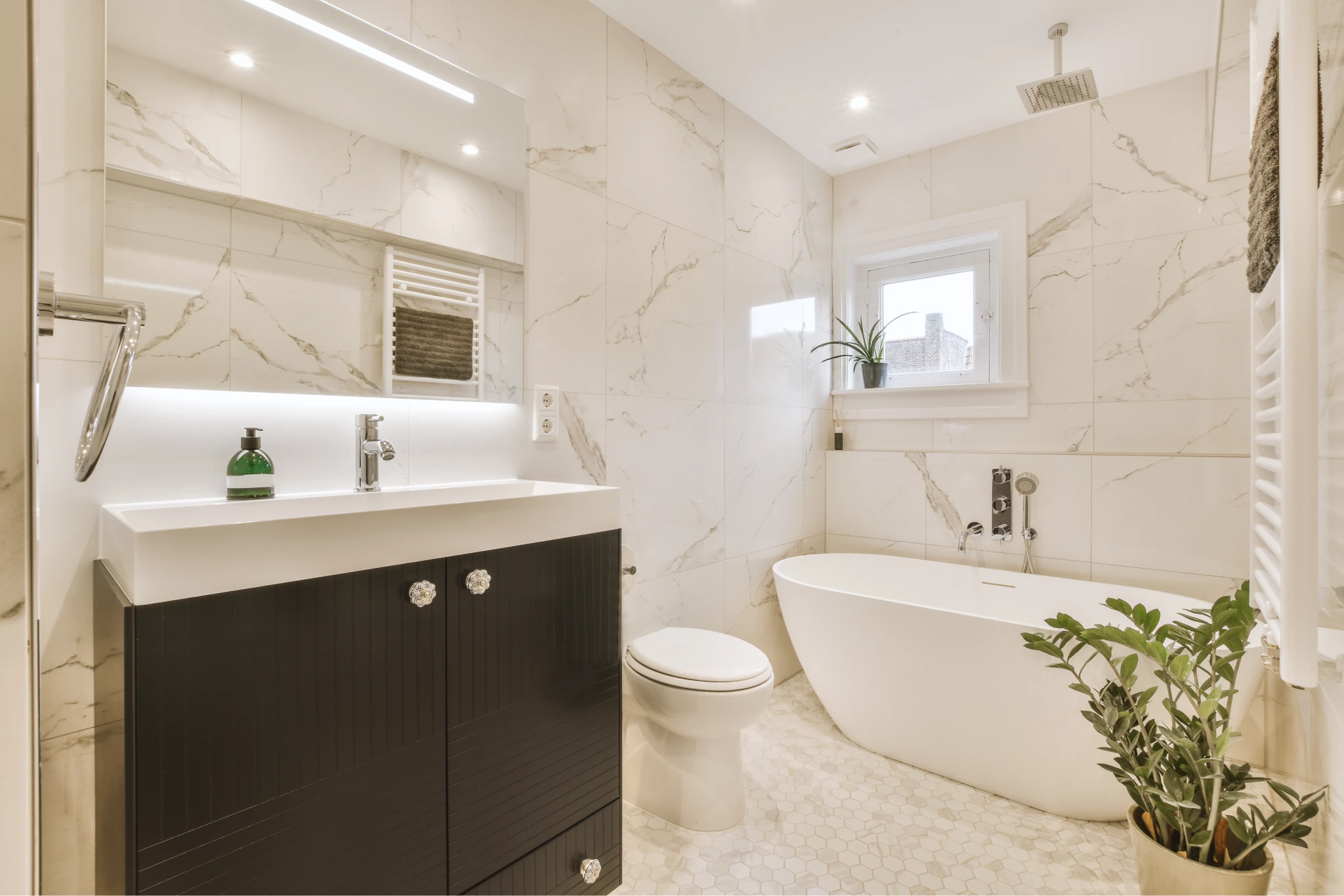 Primary bathroom remodel with tiled walk-in shower and freestanding tub