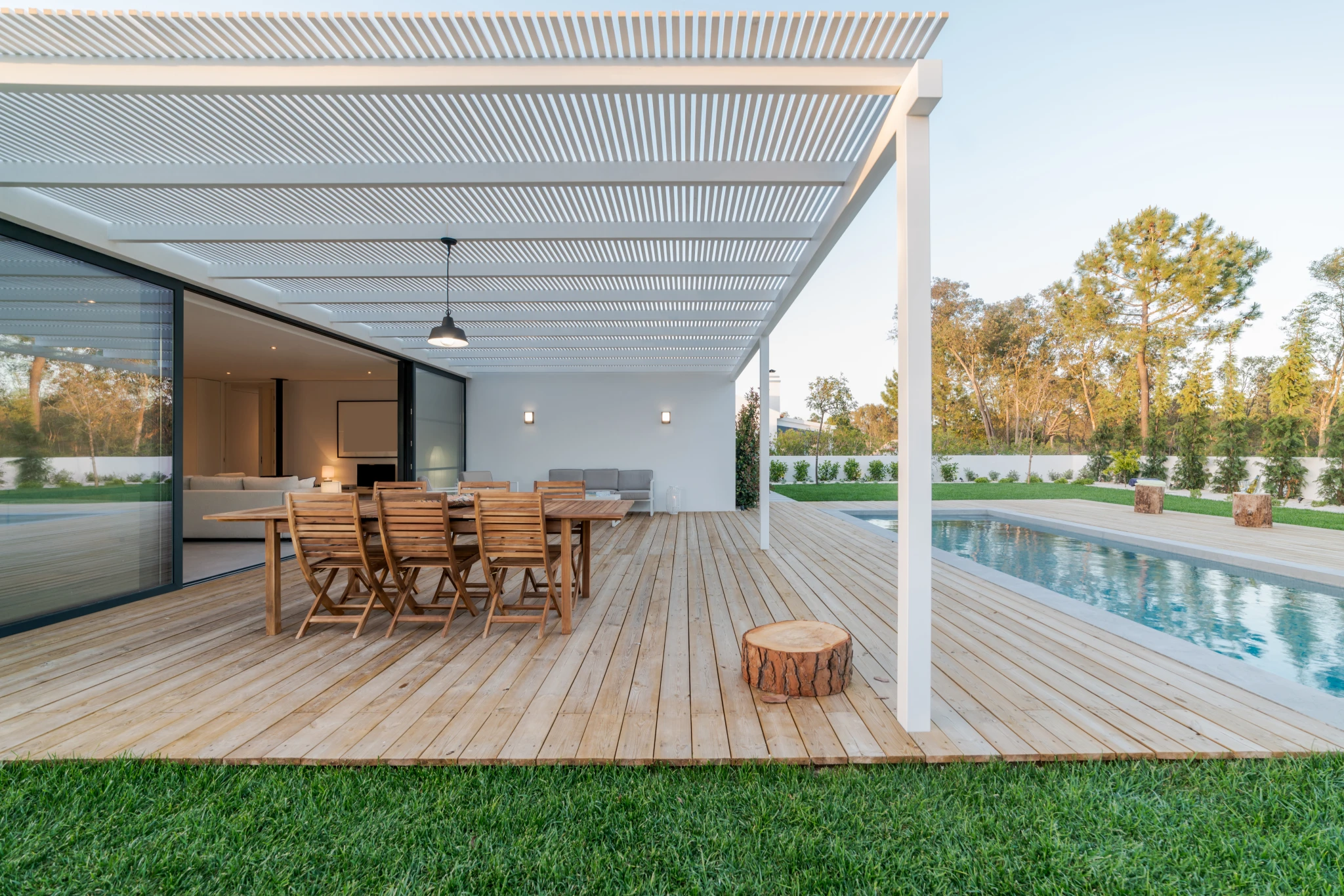 Covered outdoor living space with paver patio and outdoor fireplace